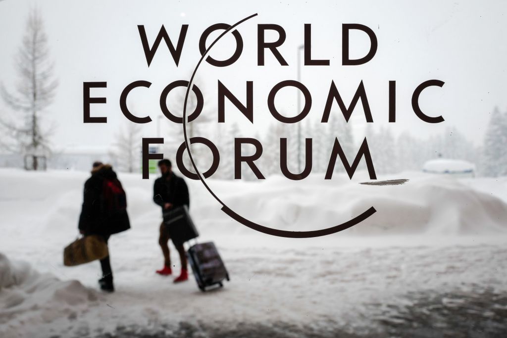 Two people leave the Congress Centre under snow ahead of the opening of the World Economic Forum WEF 2018 annual meeting in Davos eastern Switzerland. Photo: FABRICE COFFRINI/AFP/Getty Images