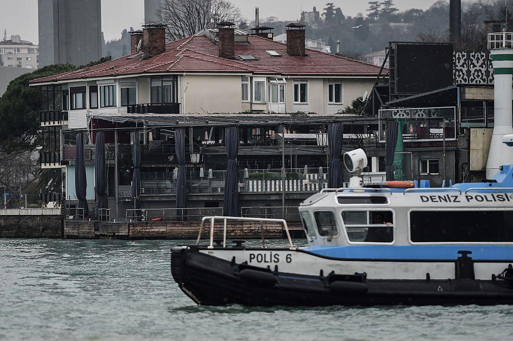 A Turkish Coast police boat (C) is anchored off the coast of the Bosphorus front of the Reina night club, one of the Istanbuls most exclusive party spots, early on January 1, 2017 after at least one gunmen went on a shooting rampage during New Years Eve celebrations. (Photo credit should read OZAN KOSE/AFP/Getty Images)