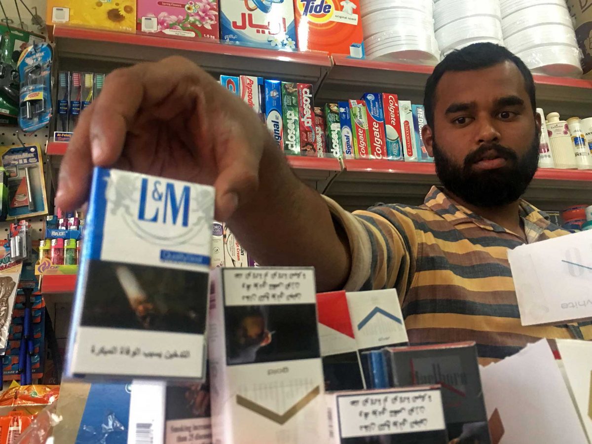 A man organises cigarette packs at a shop in in Ras Al Khaimah. (KARIM SAHIB/AFP/Getty Images)