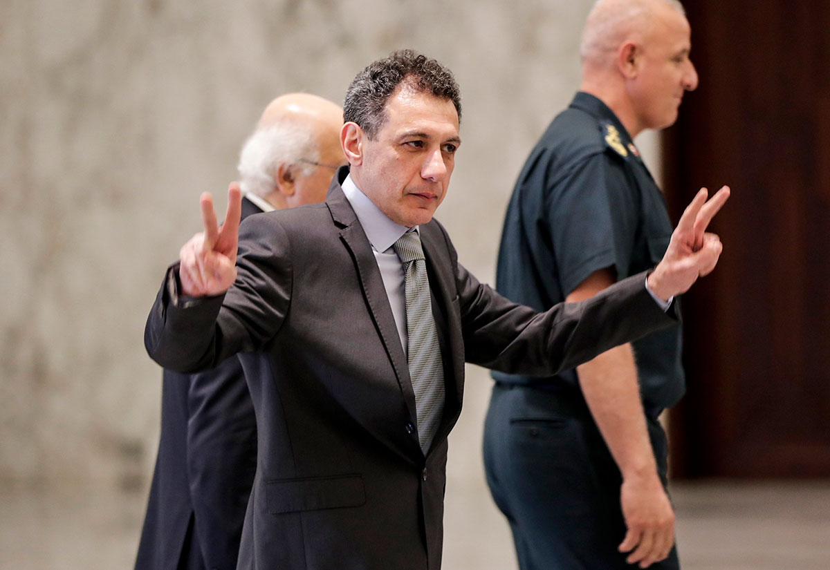 Nizar Zakka, a Lebanese national and US resident arrested in Iran in 2015 and sentenced to 10 years in jail on espionage charges, flashes the victory gesture after he was freed at the presidential palace in Baabda, east of the capital Beirut on June 11, 2019.