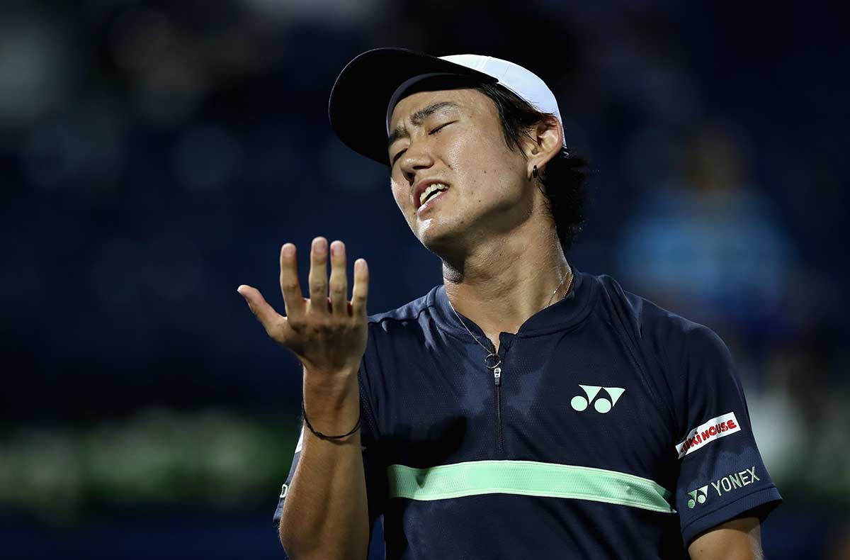 Yoshihito Nishioka of Japan reacts against Benoit Paire of France during day one of the ATP Dubai Duty Free Tennis Championships at the Dubai Duty Free Stadium on February 26, 2018 in Dubai.