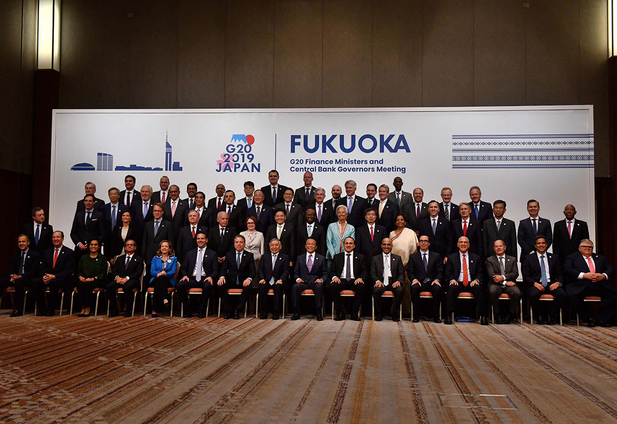 Japanese Finance Minister Taro Aso (front 8th R) and Bank of Japan governor Haruhiko Kuroda (front 8th L) pose with other delegation members during a family photo session at the G20 finance ministers and central bank governors meeting in Fukuoka.