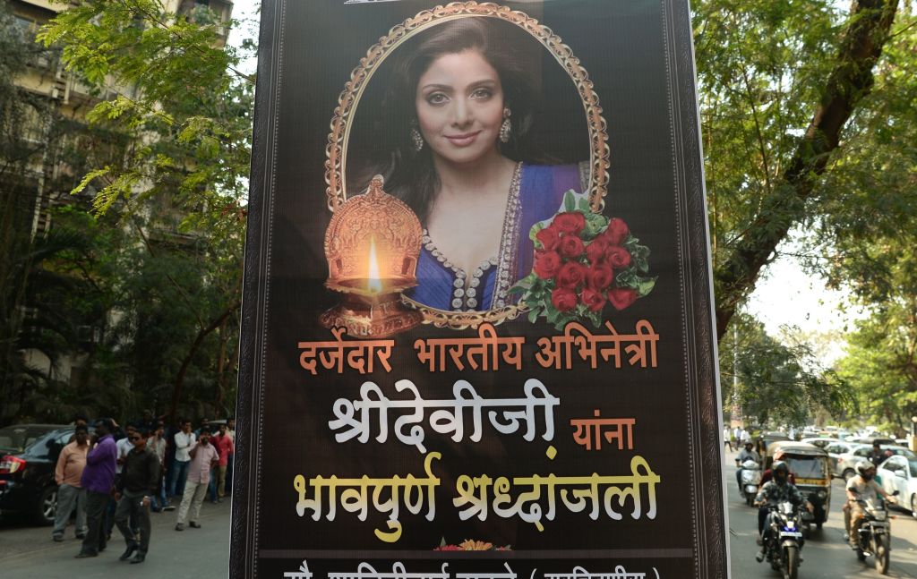 A picture of Bollywood actress Sridevi Kapoor is put up outside her residence in Mumbai on following her deathHeartbroken fans on February 26 awaited the arrival of the body of Bollywood superstar Sridevi Kapoor as tributes poured in for the actress who died in Dubai.